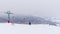 Ski lifts on the background of snow-capped mountains and a mountain glacier. Empty single chairs move up and down on