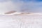 Ski marks on the snow on the peaks of the Sierra Nevada, in a high mountain area off the slopes on a foggy day