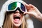 Ski mask. Sport. Extreme sport. Winter leisure. Laughing happy girl with ski mask on grey background. Snowboard glasses