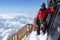 Ski mountain climber on the balcony of the mountain hut on top of Signalkuppe with a great view of the Alps around Zermatt in the