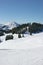 Ski piste with mountains and trees