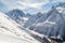 Ski piste, a small chair ski-lift against the backdrop of the Caucasus Mountains range near the town of Dombai, Russia