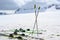 Ski poles and skis in the snow in the mountains, copy space