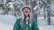 Ski resort entertainments. Happy young woman playing with snow