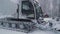 Ski resort entertainments. Snow grooming machine at ski resort. Snow grooming machine drives away leaving path of smooth