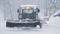 Ski resort entertainments. Snow grooming machine at ski resort. Snow grooming machine drives away leaving path of smooth