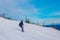 Ski resort. Freeride. Young guy on a snowboard in the mountains Sheregesh. Caucasian snowboarder on a background of blue sky .