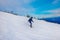 Ski resort. Freeride. Young guy on a snowboard in the mountains Sheregesh. Caucasian snowboarder on a background of blue sky .