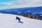 Ski resort. Freeride. Young guy on a snowboard in the mountains Sheregesh. Caucasian snowboarder on a background of blue sky .