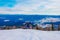 Ski resort. Freeride. Young guy on a snowboard in the mountains Sheregesh. Caucasian snowboarder on a background of blue sky .