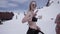 Ski resort. Girl in black bikini smile in camera. People in encamp. Skiers. Sun