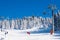 Ski resort Kopaonik, Serbia, ski lift, skier and snowboarder on the piste