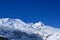 Ski resort at Mountain Ruapehu beautifully covered with snow. Majestic white-capped peaks against cloudless blue sky