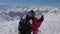 In ski resort portrait of couple skiers hugging kissing and falling in the snow