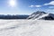 Ski resort.Ski slopes.Sunny day at the ski resort.Panoramic view on snowy off piste slope for freeriding with traces from skis, sn
