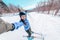 Ski selfie happy skier woman screaming of joy skiing on ski resort slopes with arms up in fun. Asian girl wearing winter