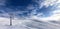 Ski slope, chair-lift on ski resort and blue sky with sunlight clouds