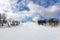 Ski slope with few ski riders skiing in the morning at ski resort with beautiful winter weather