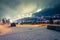 Ski slope illuminated by lanterns and wooden houses and Christmas trees at night. Lanterns and garlands illuminate the houses.