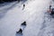 Ski slope, people skiing down the hill, mountains view