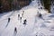 Ski slope, people skiing down the hill, mountains view