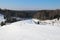 Ski slope, people skiing down the hill, mountains view. Cesis. Latvia