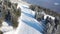 Ski slope. Skiers and snowboarders roll down the track. Aerial photography of a skier descending a wide ski slope