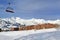 Ski slopes in french alps resort and chair lift