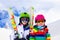 Ski and snow fun for kids in winter mountains