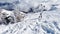 Ski in snow and overview of snowy alpine peaks panorama view