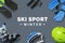 Ski sport winter text surrounded by ski accessories on table. Winter ski sport promotion concept