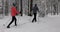 Ski touring in deep fresh snow - young couple skiing in snowy winter forest