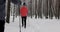 Ski touring in deep fresh snow - young couple skiing in snowy winter forest