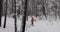 Ski touring in deep fresh snow - young couple skiing in snowy winter forest