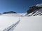 ski touring in deep snow on the glacier. Mountaineering on the Clariden in the Swiss mountains from Gemsfairenstock