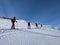 Ski touring group on the way to the summit. Mountaineering with skis in winter on the Gemsfairenstock in Uri. Swiss Alps