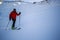 Ski touring man reaching the top at sunrise.