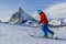 Ski touring man reaching the top in Swiss Alps.