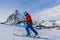 Ski touring man reaching the top in Swiss Alps.