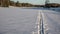 Ski trail on a field. Traces of skis and rods