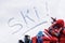 Ski vacation, winter sports, word written in snow with skiing equipment