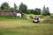 A skid steer loader clears the site for construction. Land work by the territory improvement. Machine for work in confined areas.