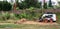 A skid steer loader clears the site for construction. Land work by the territory improvement. Machine for work in confined areas.