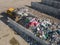 Skid steer loader moving waste material, shaking out a scrap grapple