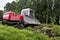 The skid tractor opens the fire-prevention strip. The skidder tractor cuts with a knife and sends the top layer of soil with the