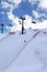 Skier ascend on snow ski slope and ski-lift at evening