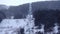 Skier on the chairlift that transports you to the top of the mountain on a day with fog and blizzard, Grandvalira