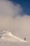 Skier climbing a snow covered mountain