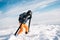 Skier climbing on snowy mountain summit