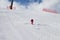 Skier descend on snowy sunlight ski slope at sun winter day